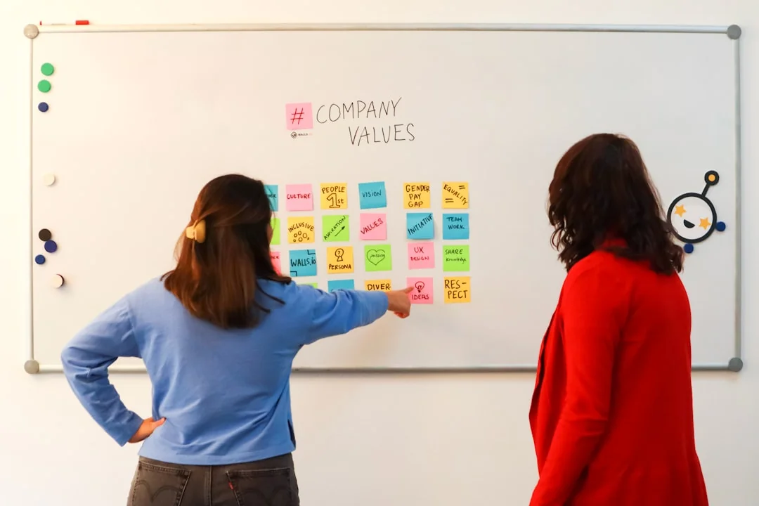 View from above of a business team reviewing charts and paper data for strategic planning.